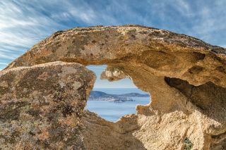 Calvi in Corsica viewed through hole in rock