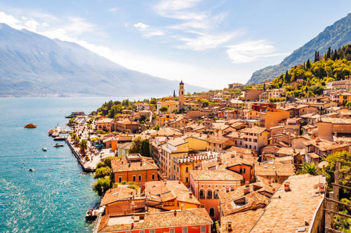 Limone Sul Garda cityscape on the shore of Garda lake surrounded